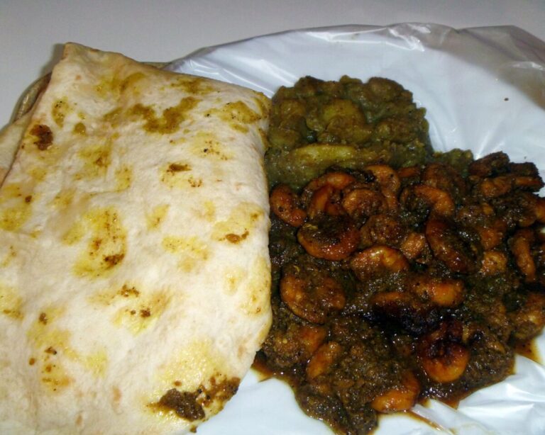 Dhalpuri roti served with channa, potato and curry shrimp in Trinidad and Tobago